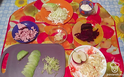 Капусту тонко нашинкуйте и помните с солью. Половину очищенной редьки натрите на крупной терке. Колбасу, свеклу и яблоко порежьте соломкой. Чеснок натрите на мелкой терке.