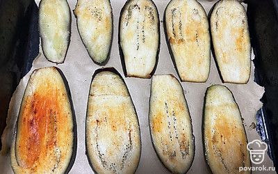 Противень застелите пергаментной бумагой. Выложите баклажан. Отправьте в разогретую до 180 градусов духовку на 25 минут.