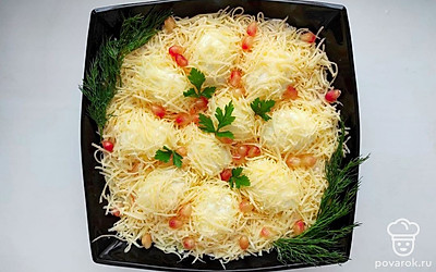 Чтобы салат приобрел более привлекательный вид, сыр немного прижмите между яйцами, чтобы образовались холмики, между ними сверху посыпьте зерна граната. Также для украшения салата возьмите зелень укропа и петрушки, предварительно промытую под проточной водой.