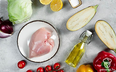 Помойте куриное филе и нарежьте его кусочками. Ополосните овощи, лимон и салат айсберг. Болгарский перец очистите от сердцевины. Очистите и помойте красный лук. Помойте лимон и выжмите сок из половины. Приготовьте форму для запекания. Разогрейте духовку до 180 градусов.