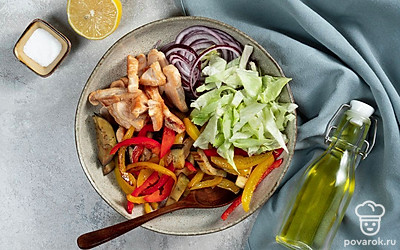 Соберите салат. Нарежьте красный лук кольцами. Латук нарвите руками. Выложите на листья айсберга курицу, запеченные овощи и лук. Добавьте оливковое масло и соль, слегка перемешайте. Сбрызните салат соком лимона.