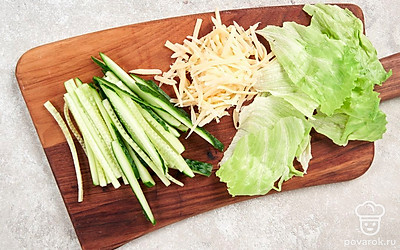 Нарежьте свежий огурец на длинные тонкие брусочки. Листья салата нарвите руками. Натрите сыр на средней или мелкой терке.