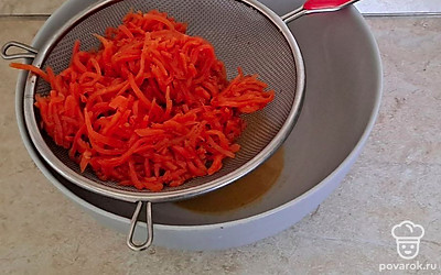 Корейскую морковь откиньте на дуршлаг, дайте жидкости стечь.