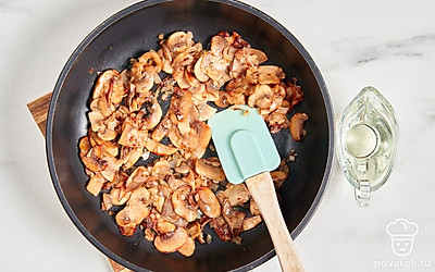 Репчатый лук нарежьте кубиками, грибы — тонкими пластинками. Поставьте сковороду на небольшой огонь. Добавьте в нее растительное масло, лук и шампиньоны. Обжарьте их в течение 3-4 минут.