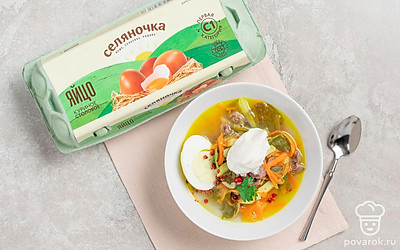 Подавайте суп с яйцом и сметаной.