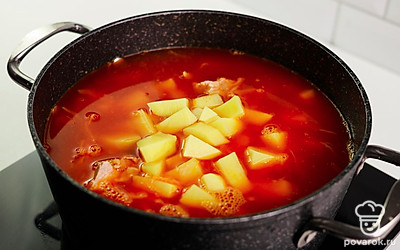 Соберите капустняк в кастрюлю. Овощи, рис и кусочки курицы залейте бульоном. Варите на медленном огне до готовности картофеля и риса.