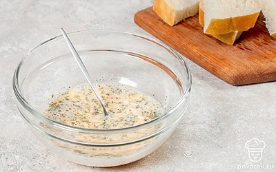 В миску разбейте яйца. Влейте к ним молоко, добавьте соль и сушеный укроп. Тщательно перемешайте ингредиенты до однородности. Батон нарежьте ломтиками. Каждый ломтик разрежьте пополам.