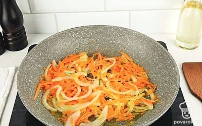 На разогретой с растительным маслом сковороде обжарьте лук и морковь.