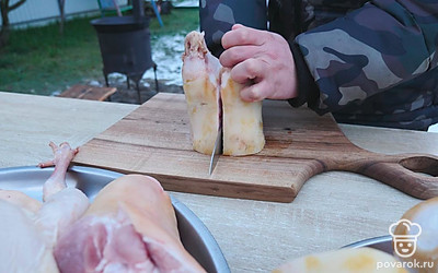 Говяжьи ноги замочите в холодной воде на 12 часов, а после этого разрежьте на пополам.