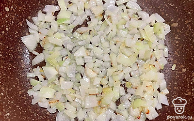 Налейте на сковороду растительное масло, слегка разогрейте его. Обажрьте произвольно нарезанный репчатый лук и зубчик чеснока до золотистого цвета.