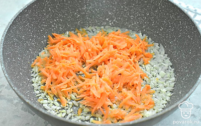 Нарежьте лук и обжарьте в растительном масле 2-3 минуты. Добавьте к луку тертую морковь, перемешайте. Продолжайте обжаривать 3-4 минуты. 