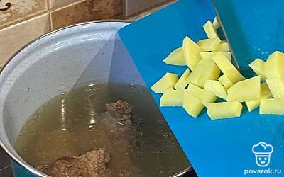 Добавьте картофель в кастрюлю с бульоном.