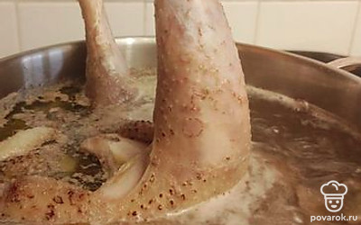 Погрузить петуха в кастрюлю, добавить лавровый лист, морковь и лук. Варить 2 часа на медленном огне.