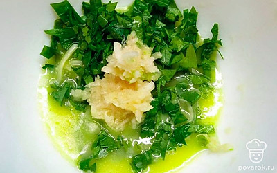 В удобной посуде смешайте нарубленную зелень с маслом и чесноком. Тщательно перемешайте получившуюся смесь.