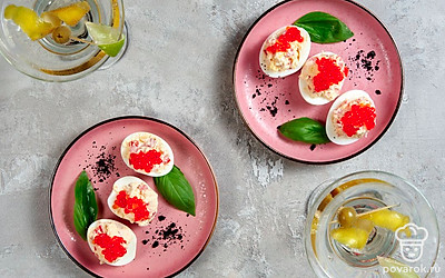 Украсьте готовые фаршированные яйца красной икрой.