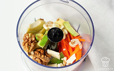 Приготовьте начинку. В чашу блендера сложите морковь и авокадо. Добавьте измельченный чеснок, орехи и молотый кориандр. Положите сыр и перебейте ингредиенты до однородного состояния пюре.