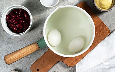 Отварите яйца. В кастрюле вскипятите воду, опустите туда яйца и варите 9-10 минут. Затем поместите яйца в миску, залейте их холодной водой и остудите. Далее очистите от скорлупы, разрежьте яйца пополам и извлеките желтки.