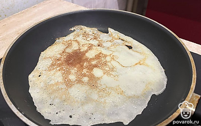 Обжариваем с одно стороны блин, смазываем сливочным маслом и ждём, когда пожарится со второй стороны. 