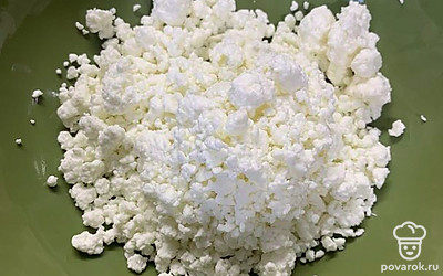 Выкладываем наш творог в тарелку и смешиваем с сахаром. 