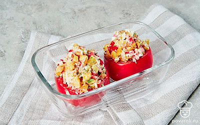 Приготовьте фаршированные картошкой помидоры. С томатов срежьте верхнюю крышечку. Удалите мякоть с семенами. Выложите начинку. Смажьте огнеупорную форму сливочным маслом. Выложите фаршированные помидоры. Поставьте в микроволновку на максимальную мощность на 5-6 минут.