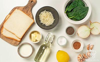 Шпинат промойте под холодной водой. Растопите в сотейнике сливочное масло и поместите туда зелень. Припустите шпинат в течение 2-3 минут, откиньте на дуршлаг. Лук и чеснок очистите, промойте, мелко порубите. Приготовьте противень. Включите духовку на 200 градусов.