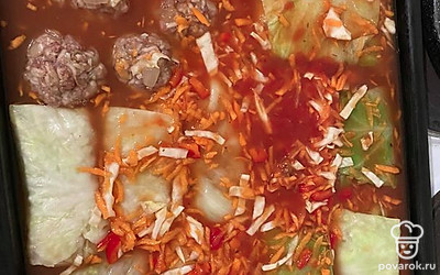 Делаем подливку: морковь трем на тёрке, мелко нарезаем капусту. Смешмваем с томатной пастой и кипяченой водой. На этом этапе можно поставить разогреваться духовку до 180 градусов. Голубцы выкладываем на противень (если остался фарш то можно скатать в шарики и тоже положить на противень). 
Когда голубцы уложены выливаем на них подливу так, чтоб она покрывала голубцы, и отправляем в духовку на 1 час.