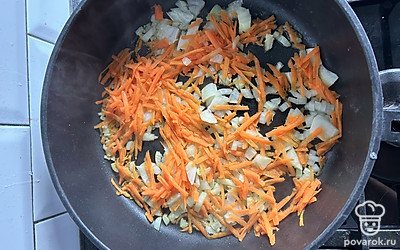 В сковородке на маленьком огне обжарить лук и морковь.