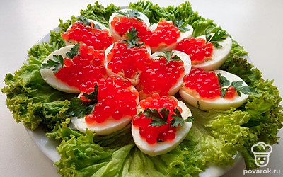 Выложите яйца на тарелку, предварительно украсив тарелку зеленью.