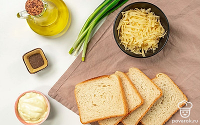 Почистите и раздавите чеснок. Зеленый лук помойте и мелко порежьте. Приготовьте сковороду, противень и блюдо для подачи. Разогрейте духовку до 180 градусов.