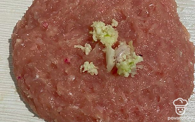 Добавьте в фарш яйцо и чеснок, тщательно перемешайте.