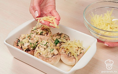 Сделайте фаршированные шампиньоны. Смажьте форму для запекания маслом. В каждую шляпку гриба выложите начинку, посыпьте сверху оставшимся сыром. Запекайте грибы в духовке 15-20 минут при температуре 190 градусов.