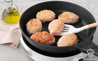 Налейте на сковороду растительное масло, разогрейте его на среднем огне. Выложите в масло котлеты, обжарьте их по 3-4 минуты с каждой стороны до плотной румяной корочки. Переложите обжаренные котлеты на тарелку.