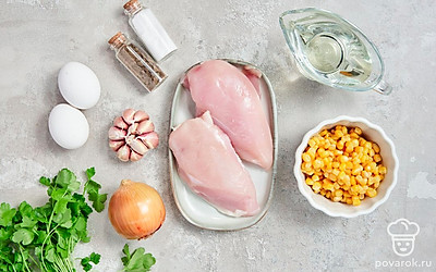 Вымойте овощи, яйца и зелень, высушите их полотенцем. Очистите лук и чеснок от шелухи. Почистите морковь от кожуры. Порежьте лук и морковь кубиками. Мелко нашинкуйте чеснок и петрушку. Откройте банку с кукурузой, слейте из нее воду. Вымойте филе курицы, обсушите, удалите пленки и нарежьте очень мелкими кусочками.