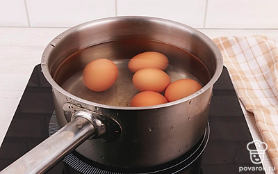 Возьмите кастрюлю или сотейник и отварите куриные яйца вкрутую. Варите яйца 10 минут после момента закипания воды.