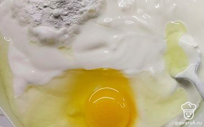 В сметану добавляем разрыхлитель и яйцо. Смешиваем. 