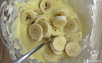 Выложите банановые кусочки в готовое тесто и разомните вилкой.