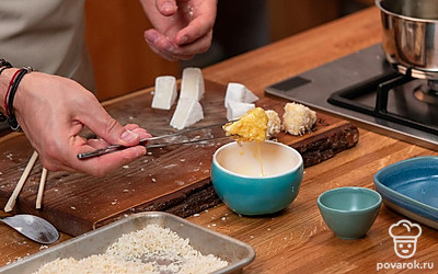 Яйцо взбейте до однородной текстуры, панировку распределите в две пиалки. Подмороженный сыр обмакните в муку и стряхните излишки. Далее сыр обмакните в яйцо, затем в первую пиалку с панировкой, затем снова в яйцо, затем снова в панировку. После этого сыр следует обжарить во фритюре.