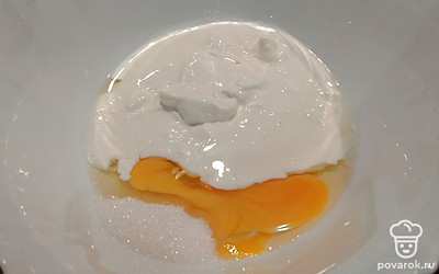 Вбейте в миску яйцо, добавьте сметану, сахар, соль и перемешайте. 