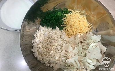 Положите в большую миску сыр, натертый на терке, творог, размельченный вилкой, нашинкованный зеленый лук (можно добавить любую зелень), нарванный лаваш на кусочки, молоко, соль, перец, вбейте яйца.