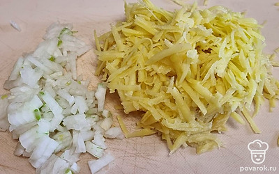 Лук очистите и мелко нарежьте. Он нужен для фарша. Картофель очистите и натрите на крупной терке. Посолите и поперчите по вкусу. 