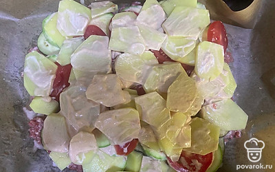 Затем выложите картофель, нарезанный кружочками. Смажьте его соусом. Отправьте в разогретую до 200 градусов духовку примерно на 45 минут.