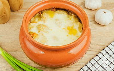 Пельмени украшаются зеленью и подаются на стол прямо горшочке.