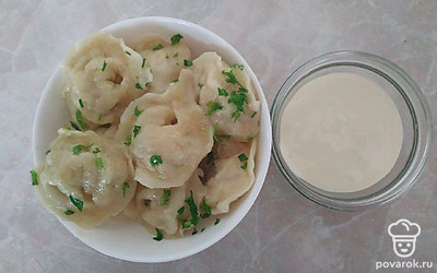 Вареные пельмени подайте с маслом или со сметаной. Притрусите их зеленью.