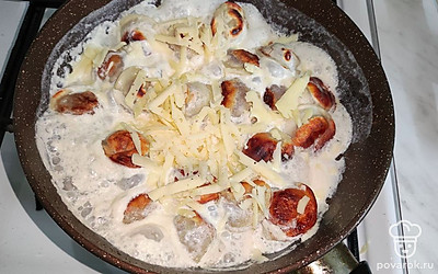 Сыр натрите на крупной терке, добавьте к пельменям, накройте крышкой, готовьте на слабом огне еще 3-5 минут.