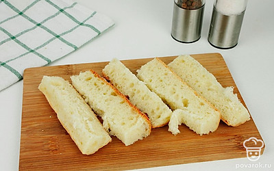 Нарежьте багет брусочками толщиной 1 см.