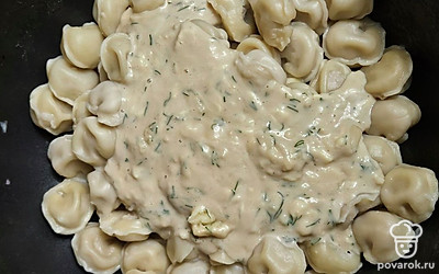 Залейте пельмени соусом. Аккуратно перемешайте.