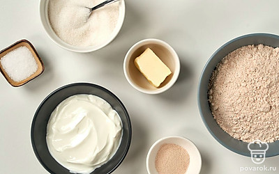 Муку просейте. Йогурт и сливочное масло достаньте из холодильника за час до приготовления багета, чтобы они нагрелись до комнатной температуры. Воду нагрейте до 60 градусов. Подготовьте форму для выпечки и застелите ее специальной бумагой. Нагрейте духовку до 180 градусов.