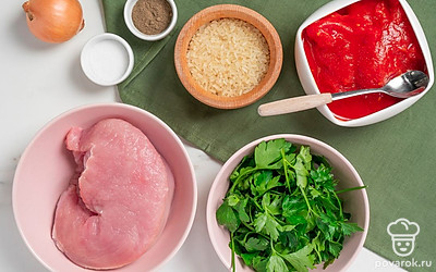 Промойте филе индейки, почистите от пленок и обсушите. Сполосните овощи и зелень, просушите их полотенцем. Почистите лук от шелухи. Откройте банку с помидорами, выложите необходимое количество. Отварите рис для подачи. Разогрейте подсолнечное масло на сковороде.