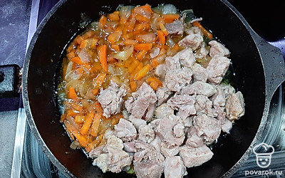 К обжаренным луку и моркови в сковородку добавляем отварное мясо и мясной бульон. 