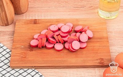 Нарежьте сосиски кружочками толщиной 2-3 мм.